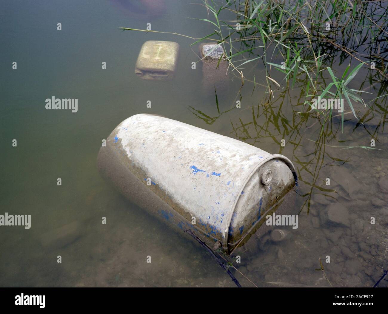 Dumped chemical containers. Containers dumped in dirty water at the