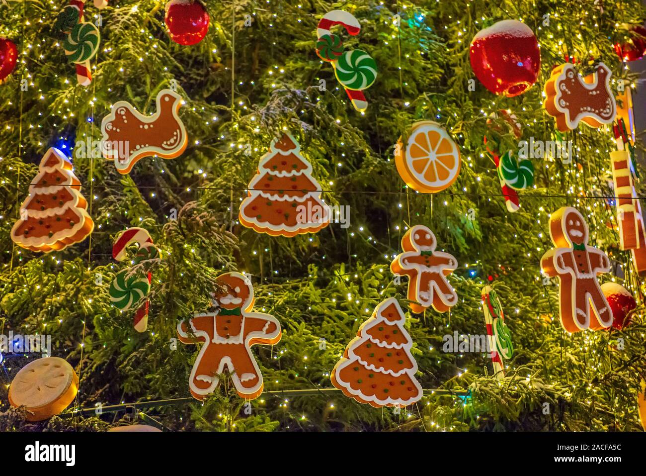 Christmas tree decorations background. Garlands, gingerbread man and candy  canes Stock Photo - Alamy