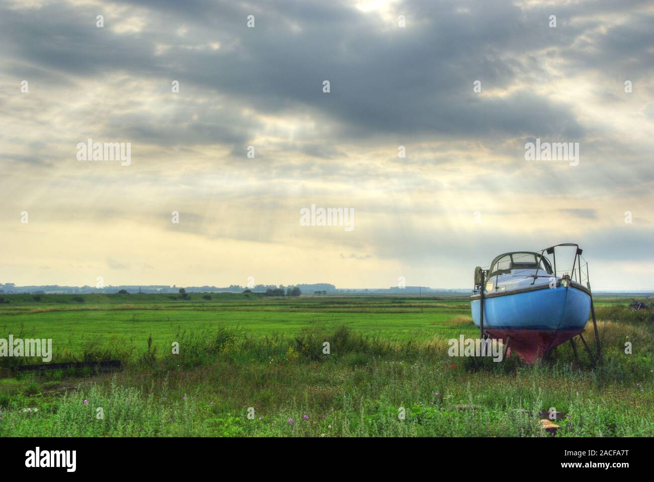 A small boat sits idly on it's own. Abandoned maybe. Stock Photo
