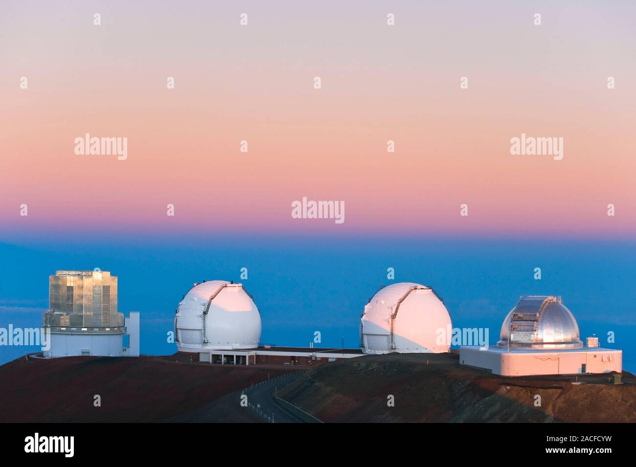 Observatories at the summit of Mauna Kea, Hawaii, at sunrise. From left
