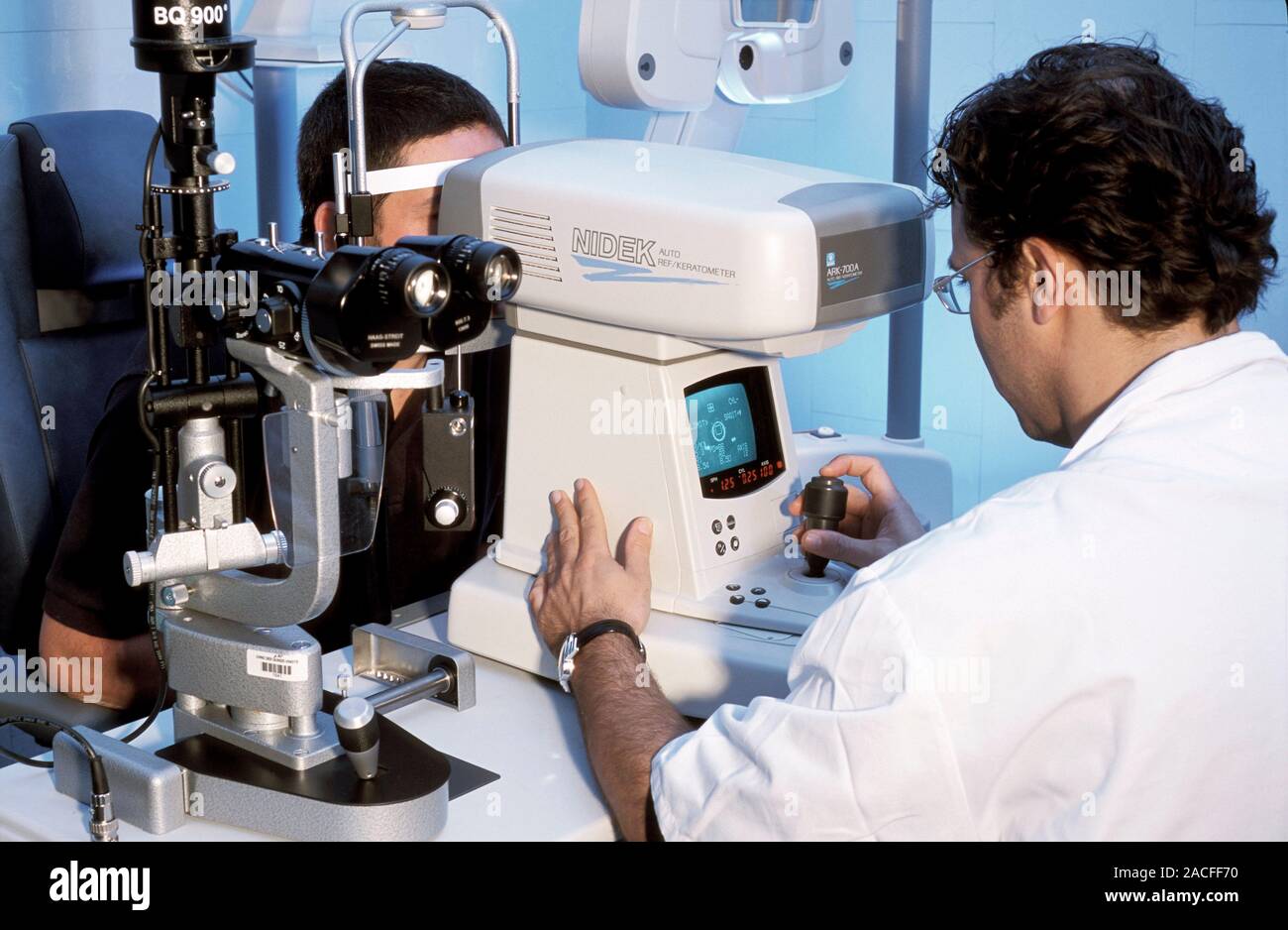 Eye examination. Doctor using a keratometer to measure the curvature of