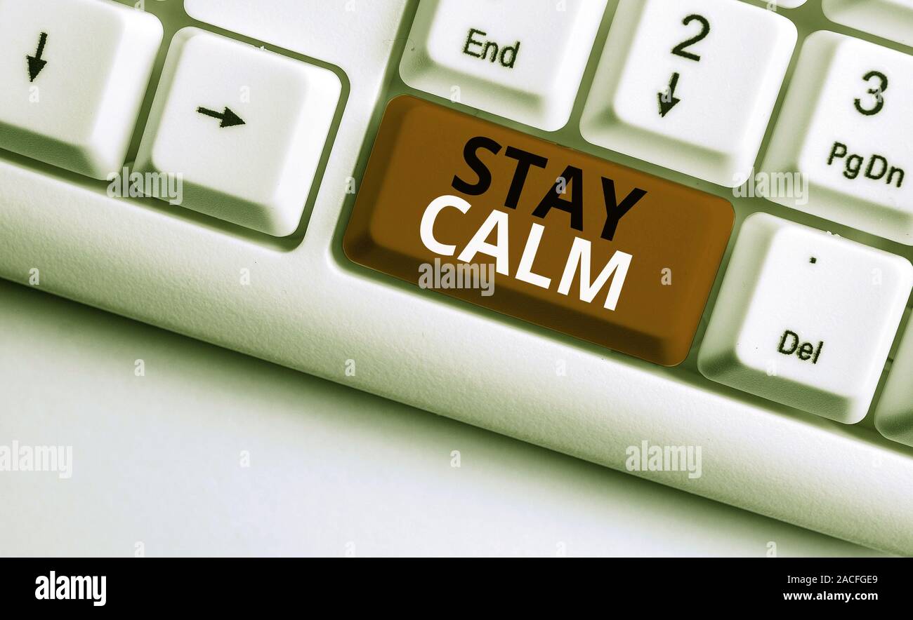 Writing note showing Stay Calm. Business concept for Maintain in a state of motion smoothly even under pressure White pc keyboard with note paper abov Stock Photo
