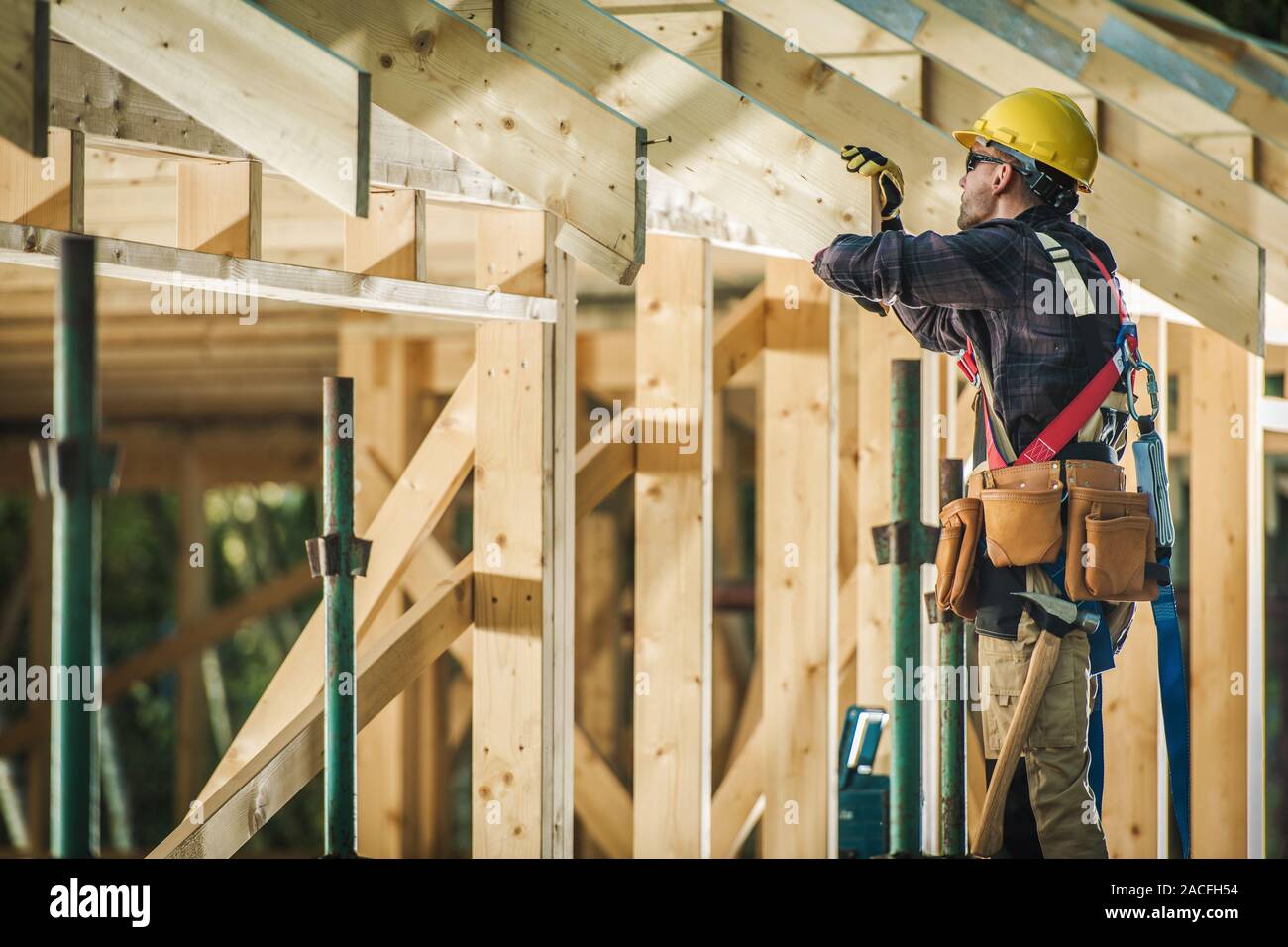 Building Industry. Wood Material House Building. Caucasian Construction Contractor at Work. Stock Photo