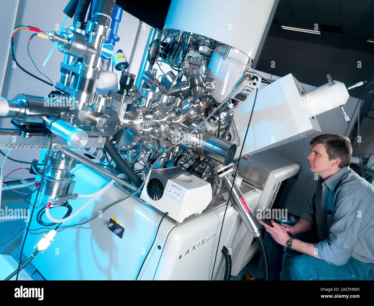 X-ray materials analysis equipment. Researcher adjusting the controls ...