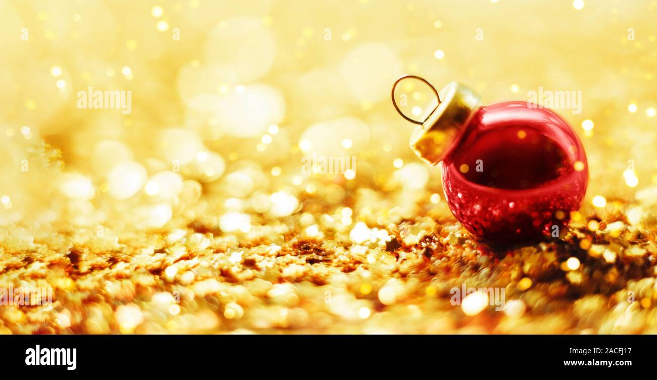 Christmas red ball on a gold shiny background Stock Photo - Alamy