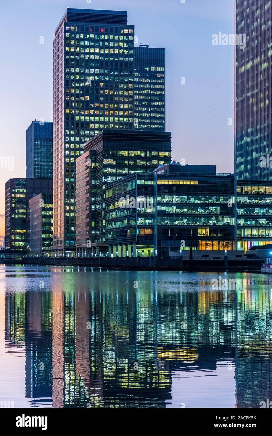 Canary Wharf South Dock - buildings around the south Dock of Canary Wharf London including Clifford Chance International Law Firm in foreground. Stock Photo
