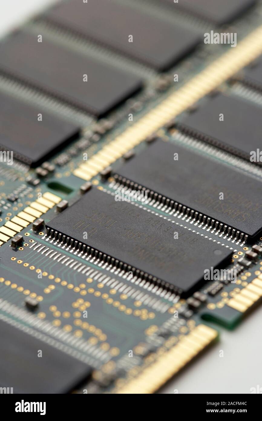 Computer memory chips. RAM (random access memory) chips (grey) on two circuit boards from a computer. Stock Photo