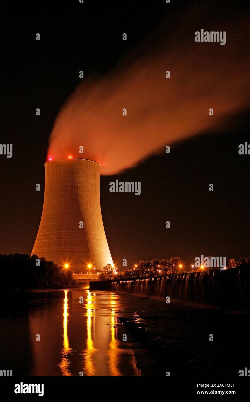 Nuclear power plant cooling tower at night. Cooling towers are used to