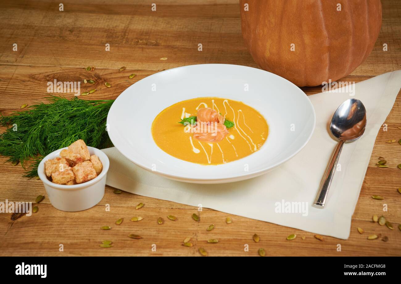 Pumpkin soup with sliced salmon Stock Photo