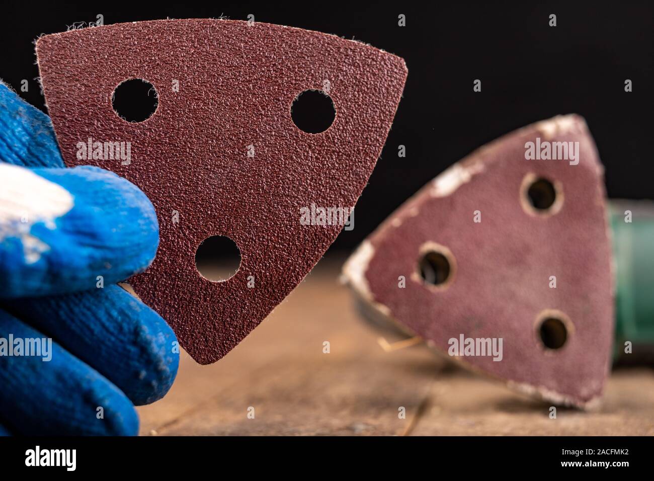 Changing sandpaper in a rotary wood grinder. Work tool in a carpentry