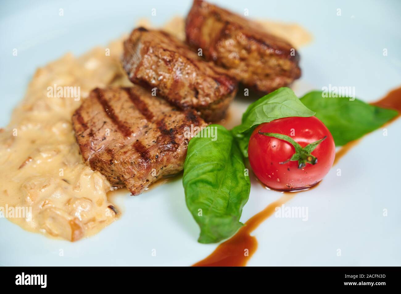 Close-up of beef steaks with tomato and sauce. Top view Stock Photo