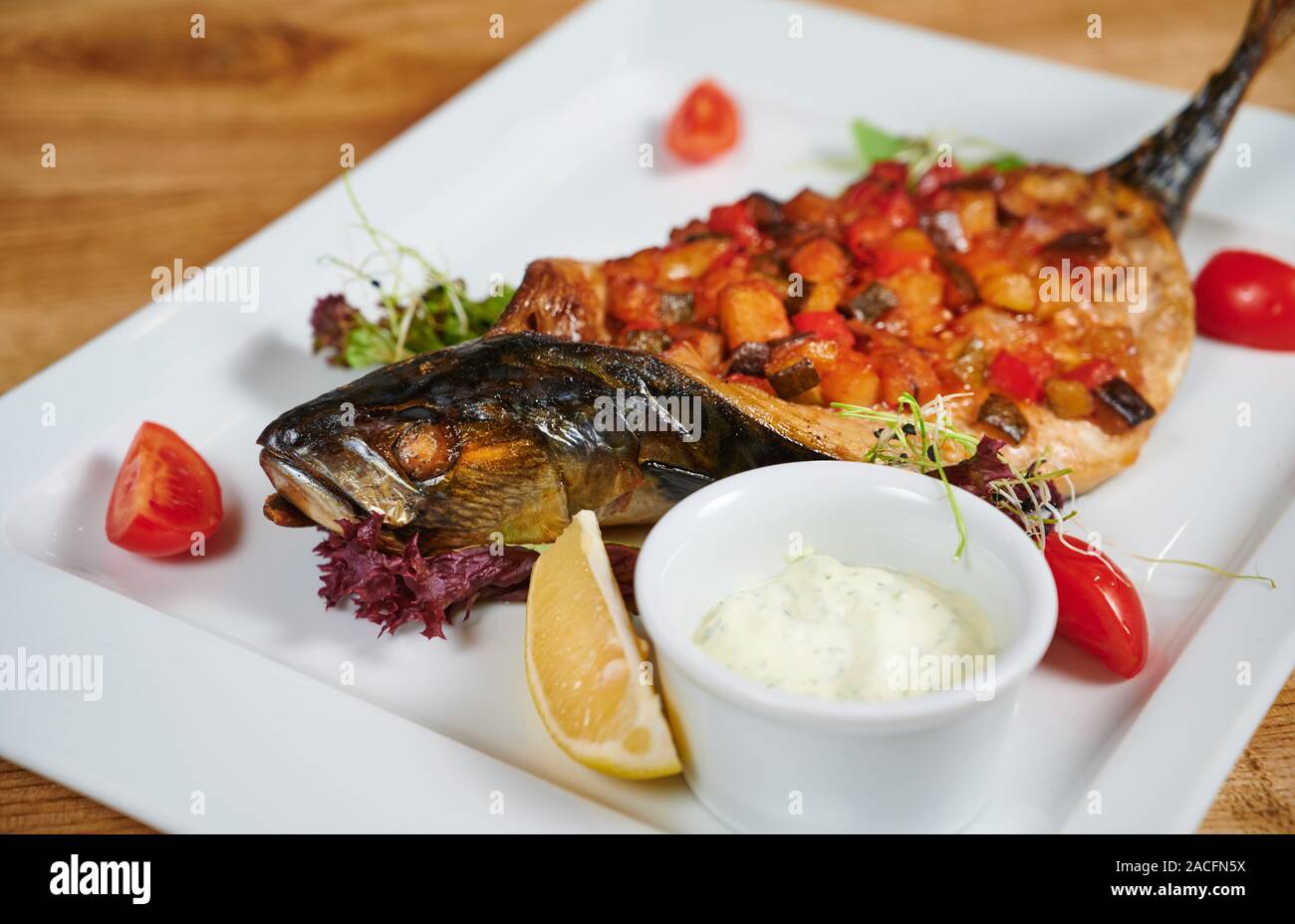 Grilled fish stuffed with different vegetables Stock Photo