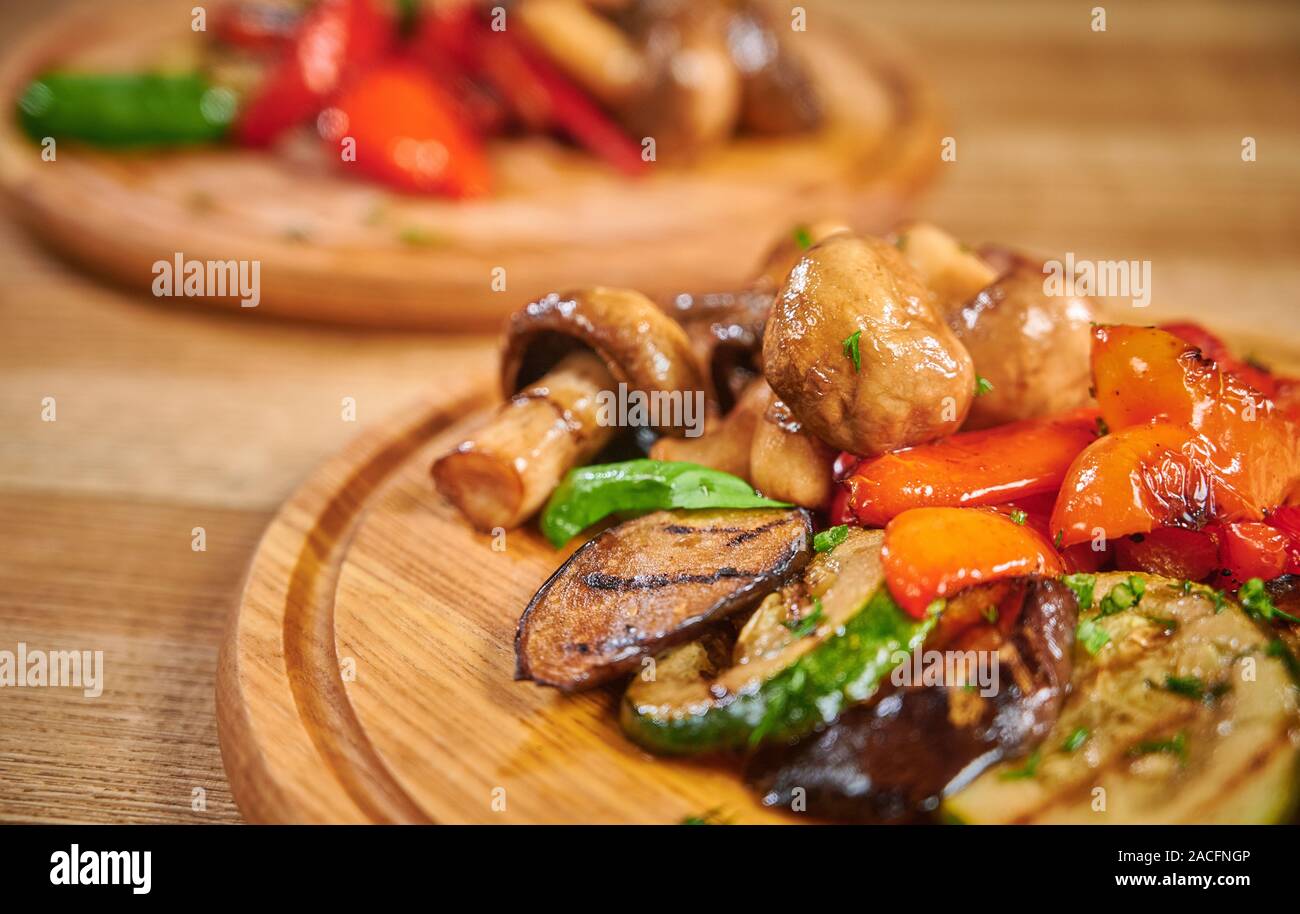 Grilled vegetables mix on wooden plate Stock Photo