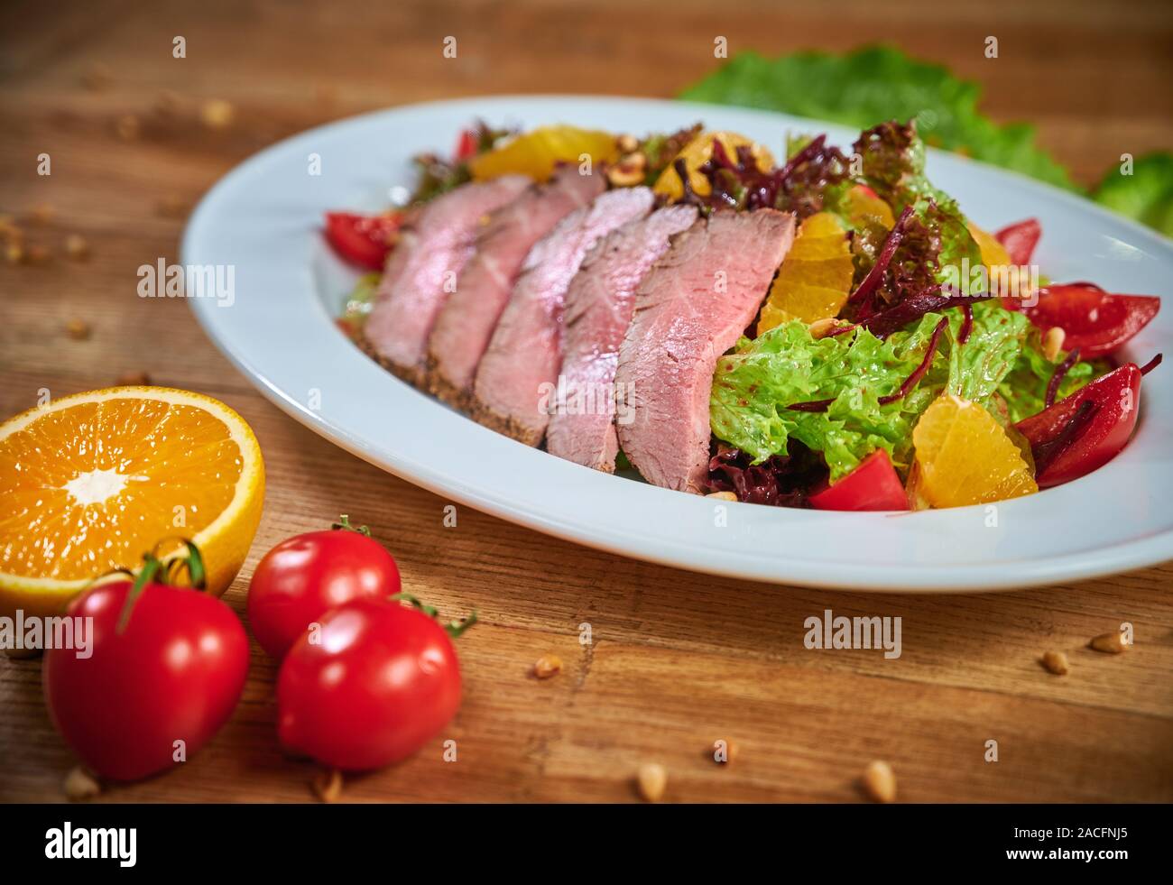 Plate with mouthwatering gourmet dish with roasted duck breast and salad with vegetable Stock Photo