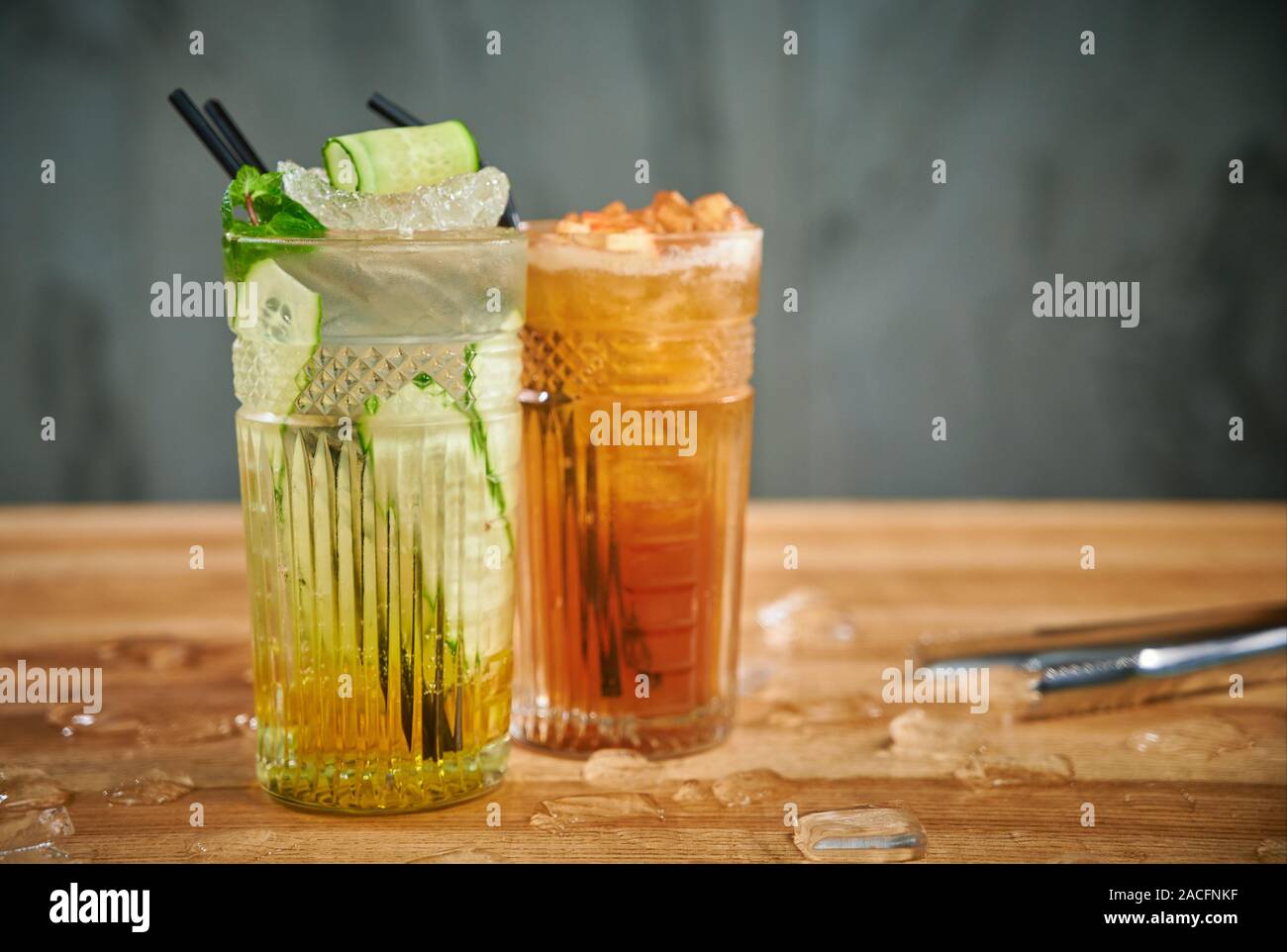 Two glasses with refreshing drinks. Delicious refreshing waters with cucumber and cinnamon in glasses Stock Photo