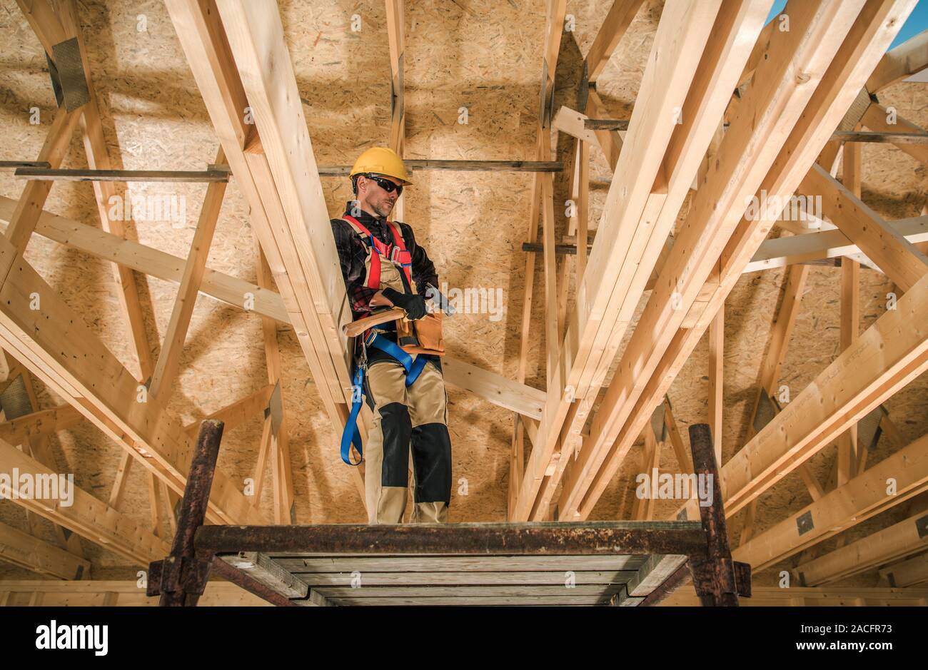 Skeleton Wood Construction of Newly Developed House. Caucasian Construction Contractor Job. Industrial Theme. Stock Photo
