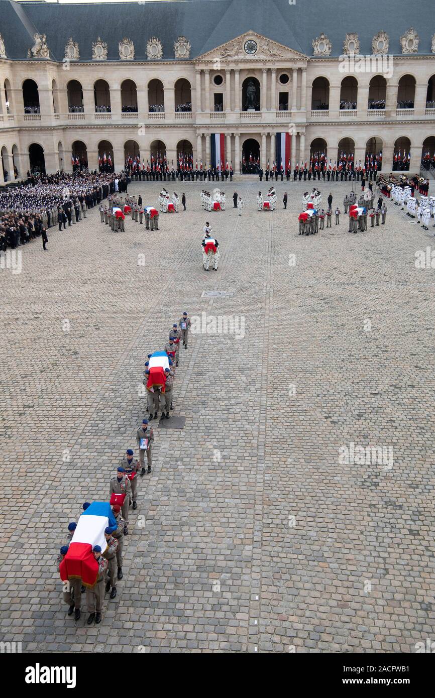 Paris, France. 2nd Dec, 2019. Soldiers carry flag-draped coffins of the fallen servicemen during a tribute ceremony at the Les Invalides in Paris, France, on Dec. 2, 2019. France held the ceremony here on Monday to pay tribute to 13 soldiers who died in a helicopter accident in Mali a week ago. Credit: Jack Chan/Xinhua/Alamy Live News Stock Photo