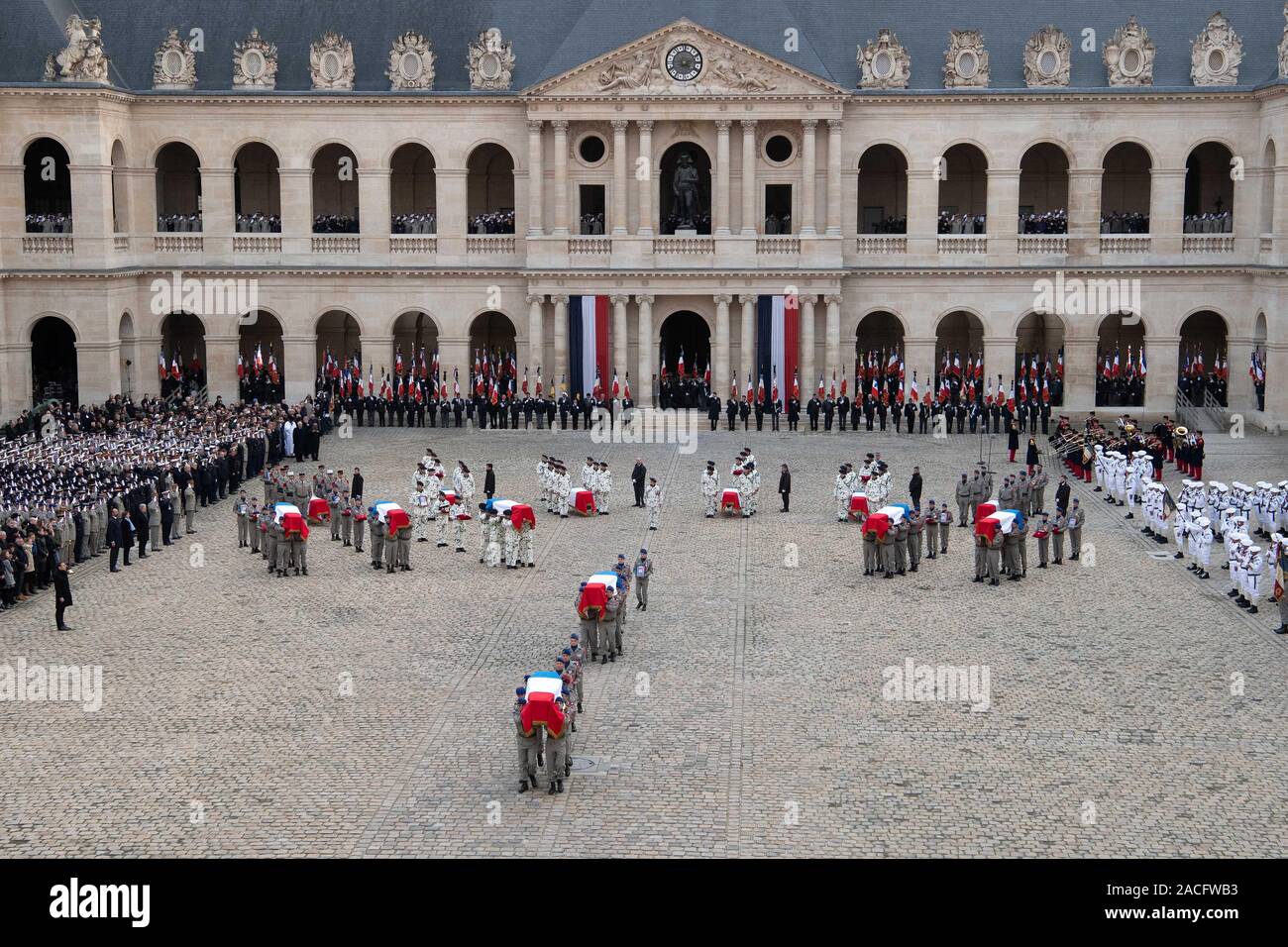 Paris, France. 2nd Dec, 2019. Soldiers carry flag-draped coffins of the fallen servicemen during a tribute ceremony at the Les Invalides in Paris, France, on Dec. 2, 2019. France held the ceremony here on Monday to pay tribute to 13 soldiers who died in a helicopter accident in Mali a week ago. Credit: Jack Chan/Xinhua/Alamy Live News Stock Photo