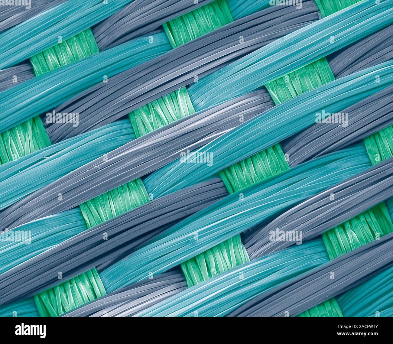 Woven silk, coloured scanning electron micrograph (SEM). Silk is a