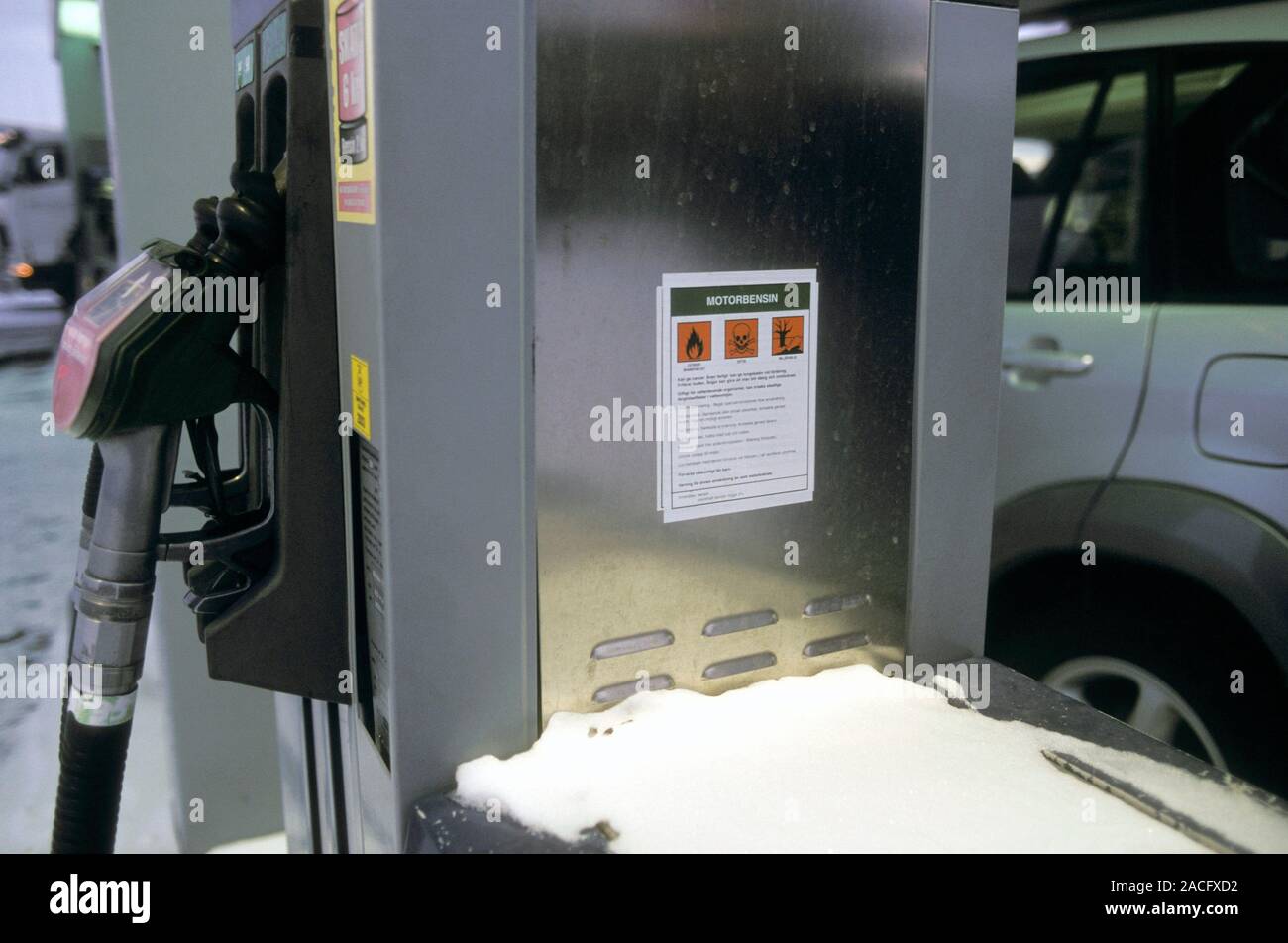 Petrol station warning sign on the side of a petrol pump. Photographed