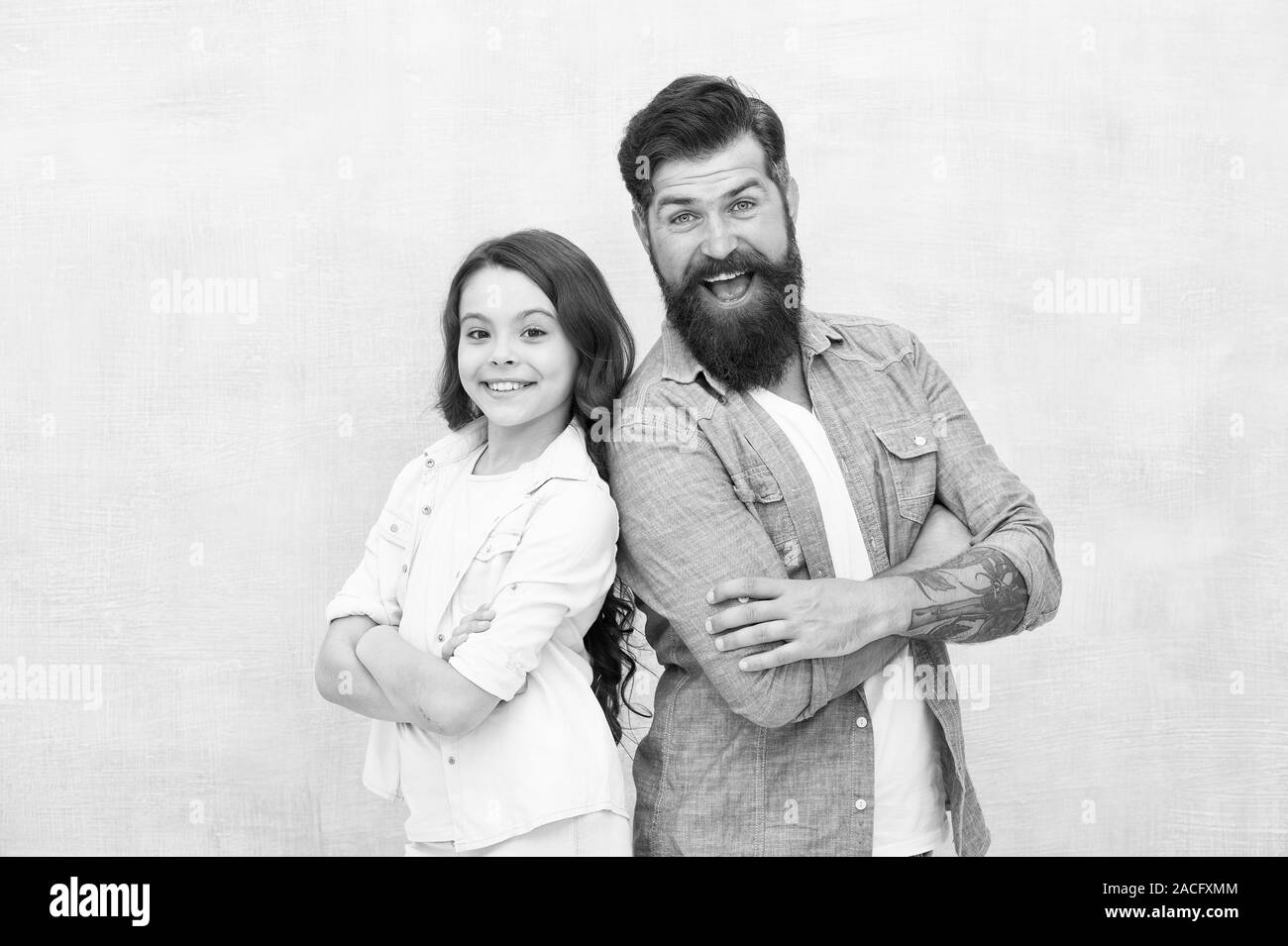 My dad is always there. Happy dad and adorable little daughter smiling on grey background. Bearded dad and small girl child wearing smiling in casual style. My dad is my love. Stock Photo