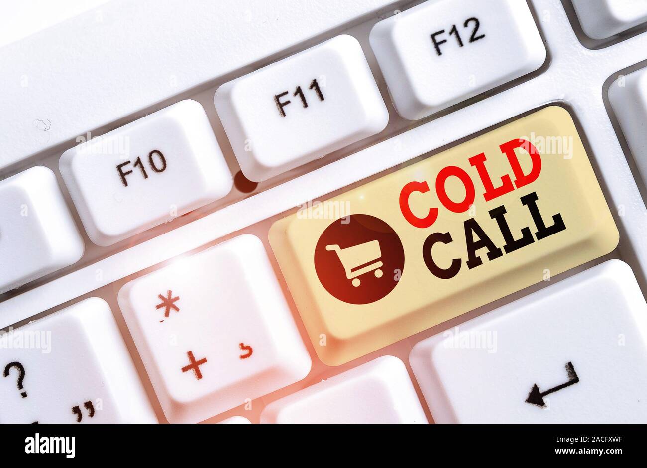 Text sign showing Cold Call. Business photo text Unsolicited call made by someone trying to sell goods or services White pc keyboard with empty note p Stock Photo