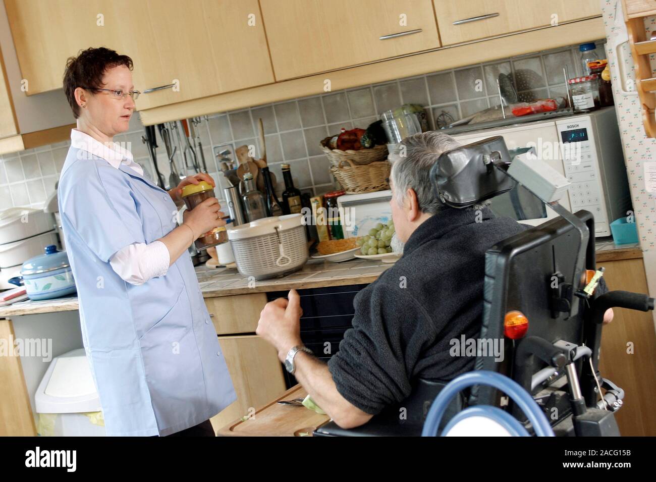 Home help for disabled person. Female medical worker helping out in the