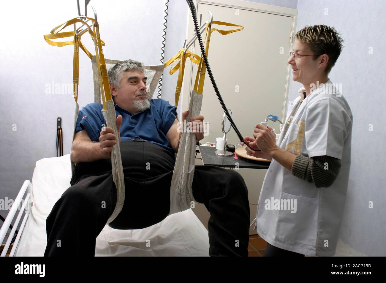 Home help for disabled person. Female medical worker helping a disabled