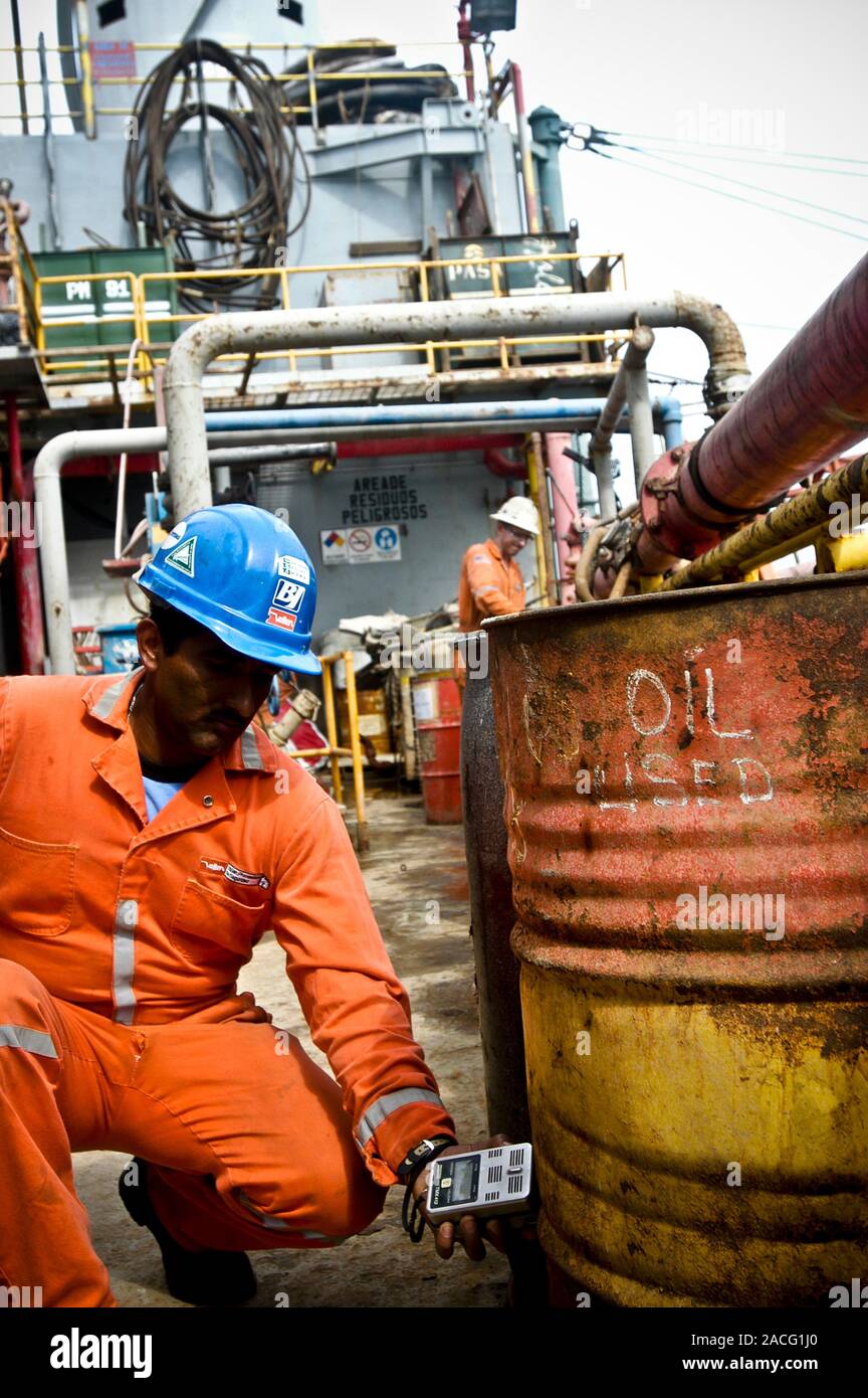 Oil industry safety tests. Safety employee measuring the level of