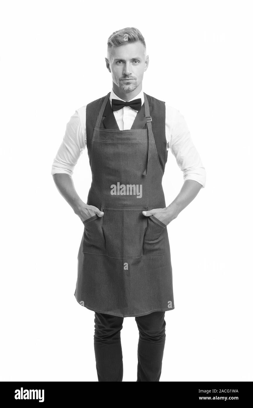 Hospitality staff. Barista handsome worker. Man cook wear apron. Mature barista. Restaurant staff. Hipster professional barista apron uniform. Waiter or bartender. Cafe bar barista job position. Stock Photo