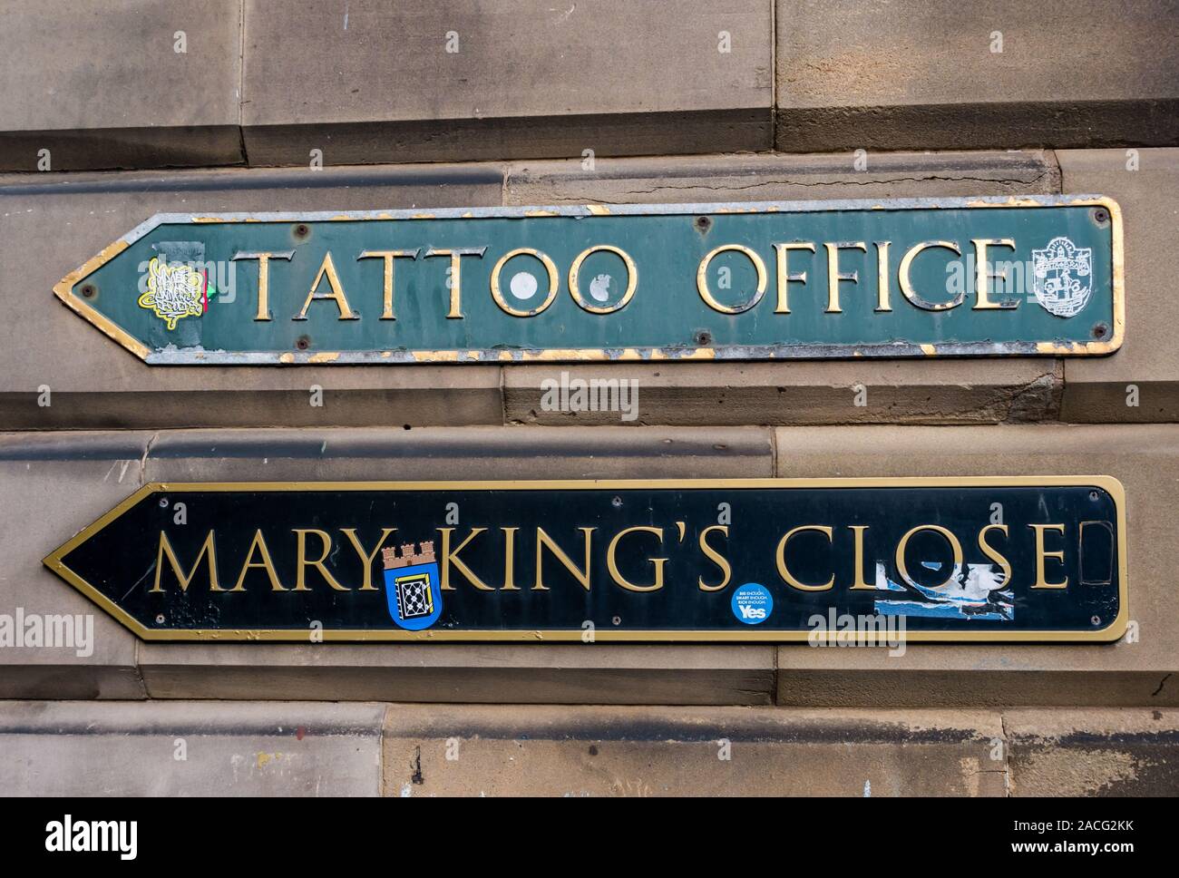 Signs for Mary King's Close & Military Tattoo Office on sandstone wall, Edinburgh, Scotland, UK Stock Photo