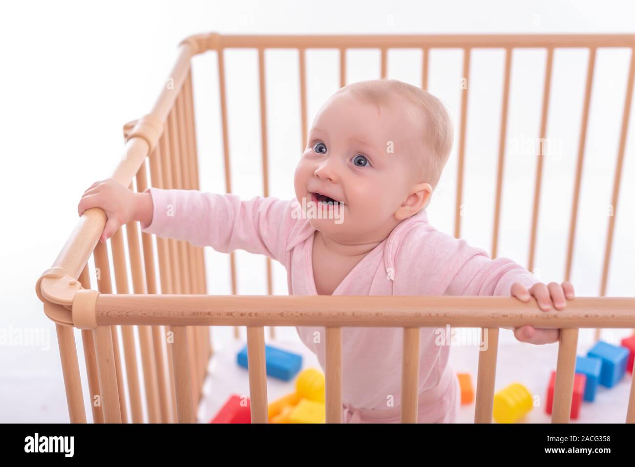 Baby girl at children's playpen Stock Photo Alamy