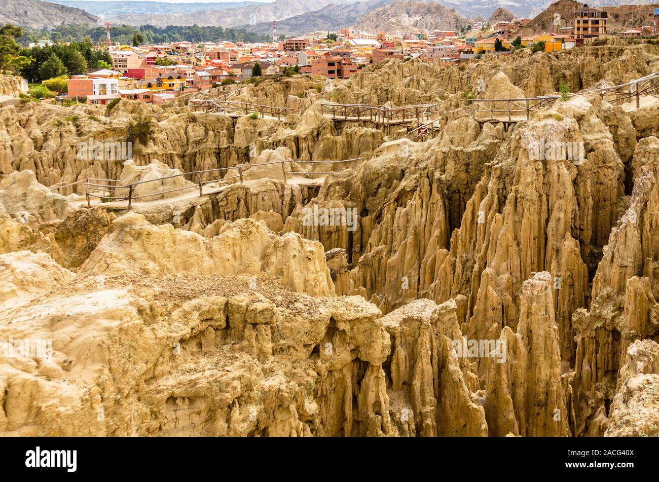 Maze of Moon Valley or Valle De La Luna  eroded sandstone spikes, with La Paz city suburb in the background, Bolivia Stock Photo