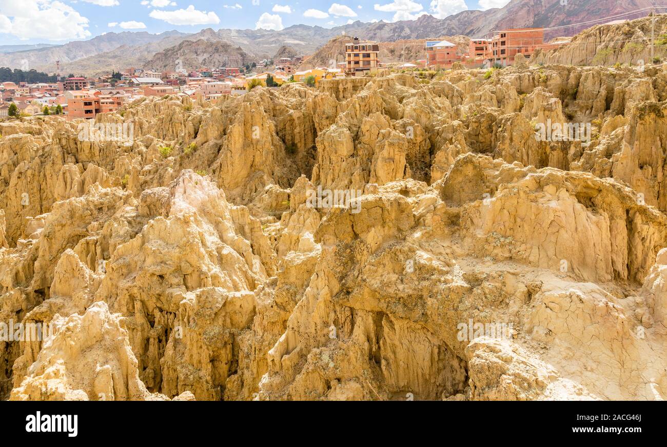 Maze of Moon Valley or Valle De La Luna  eroded sandstone spikes, with La Paz city suburb in the background, Bolivia Stock Photo