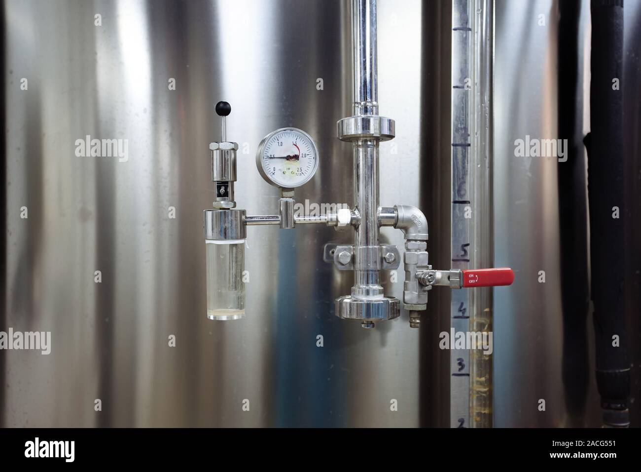 Pressure gauge and valve connected with steel tank in craft brewery Stock Photo Alamy