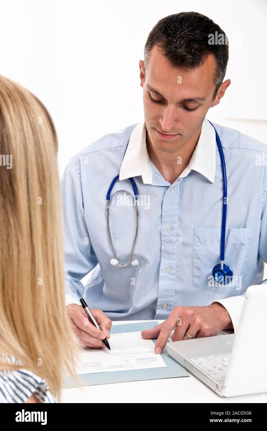 Medical consultation. Doctor taking notes whilst talking to a patient