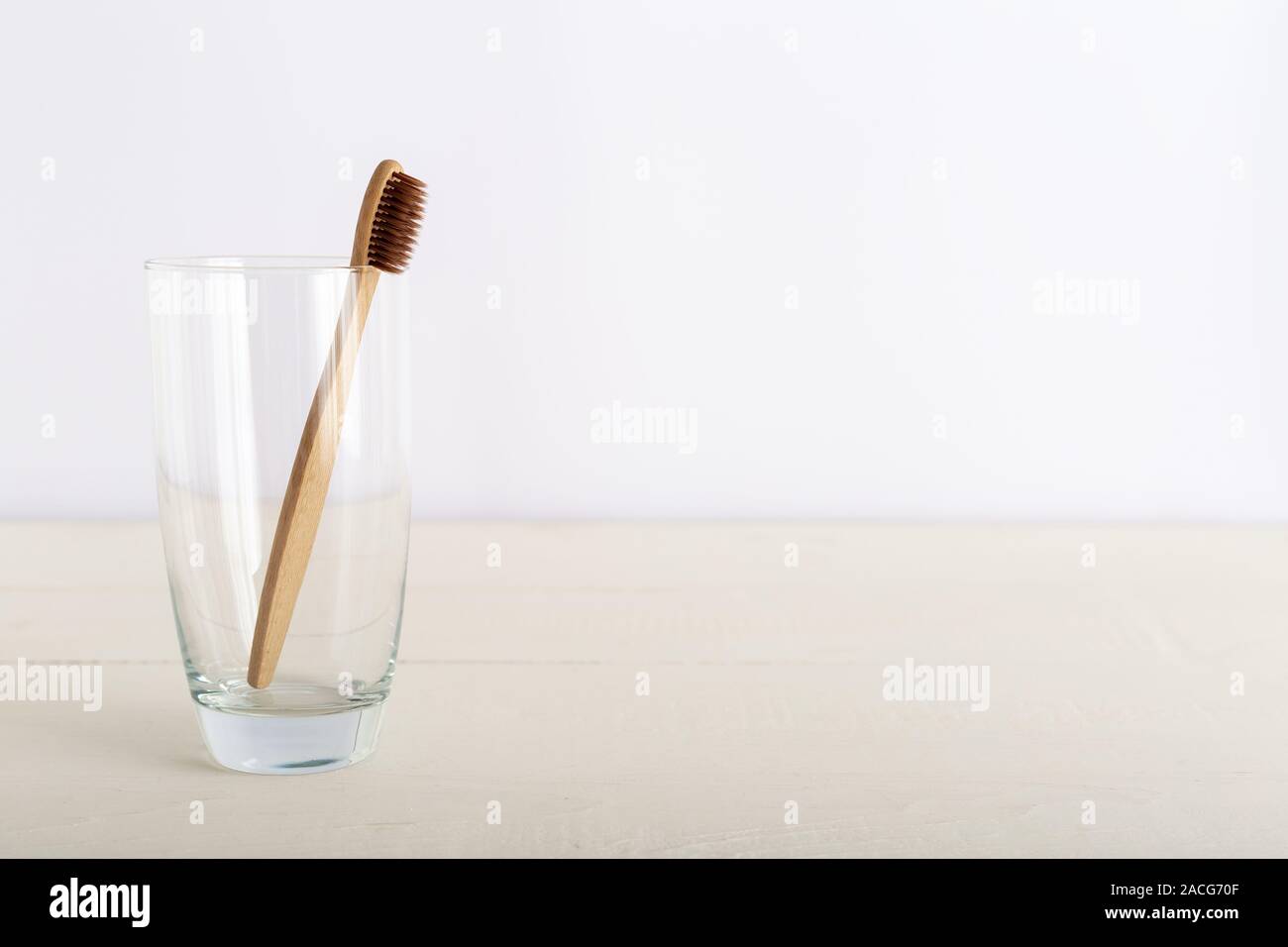 Natural bamboo toothbrushes in glass on white background. Biodegradable ...