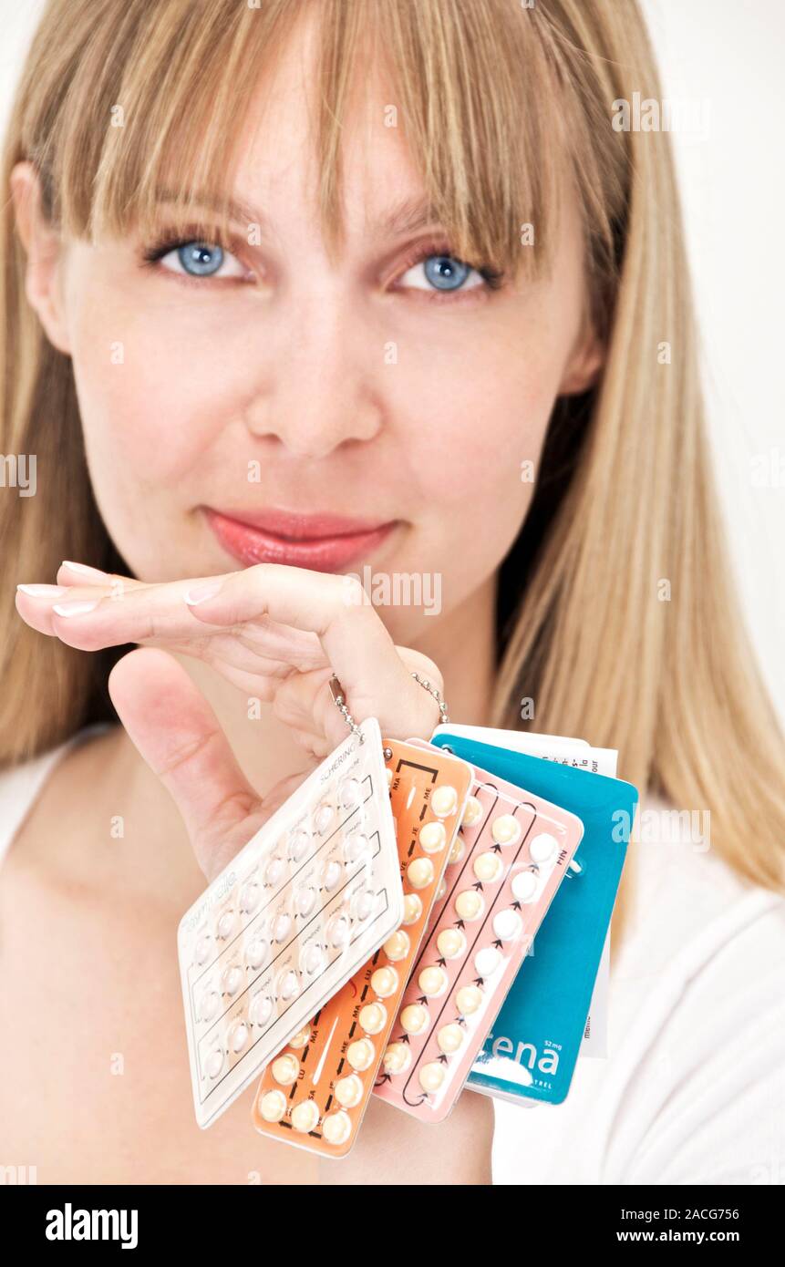 Oral contraception. Woman holding several different types of the oral contraceptive pill Stock