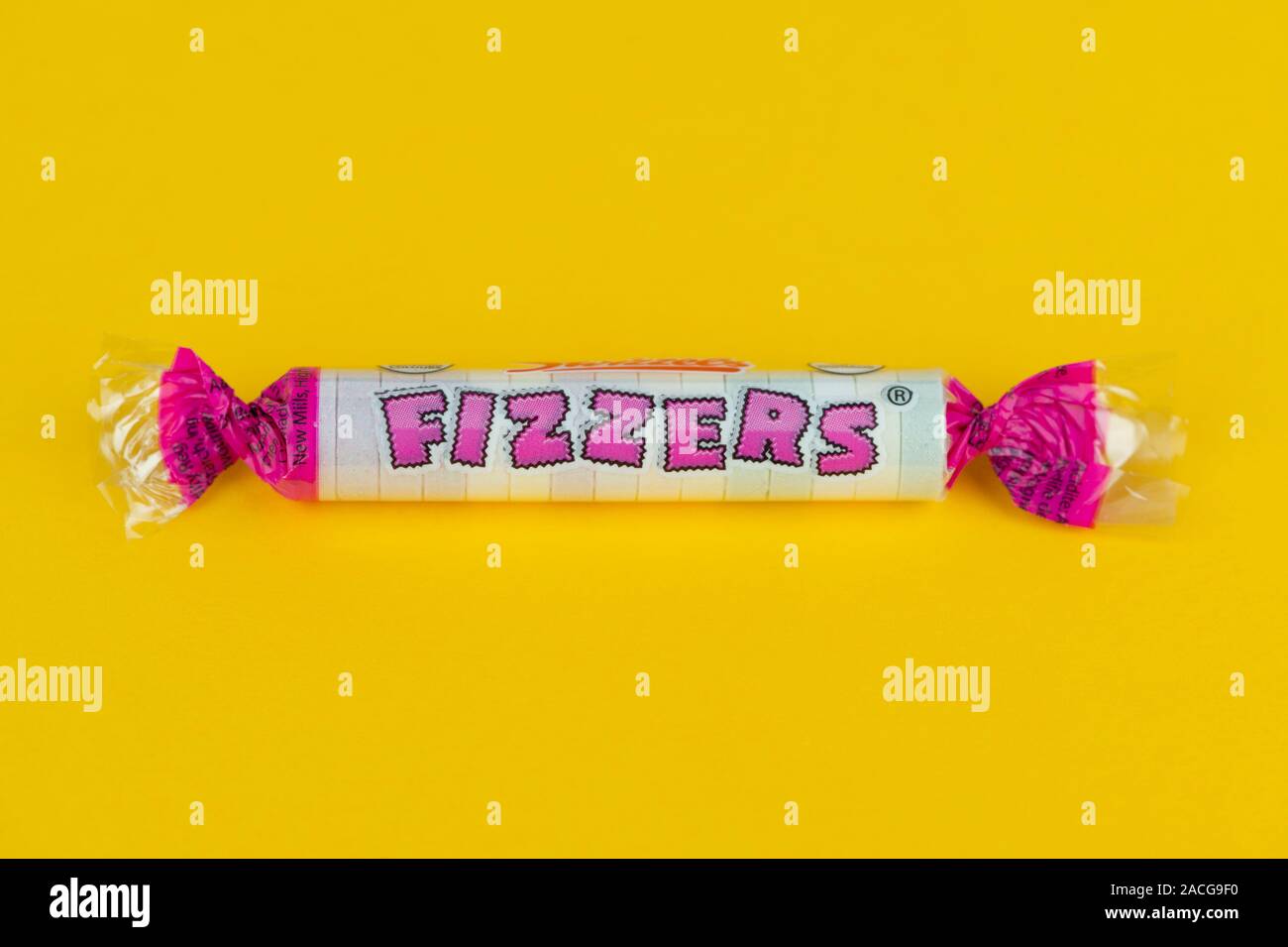 A packet of Swizzels Fizzers shot on a yellow background. Stock Photo