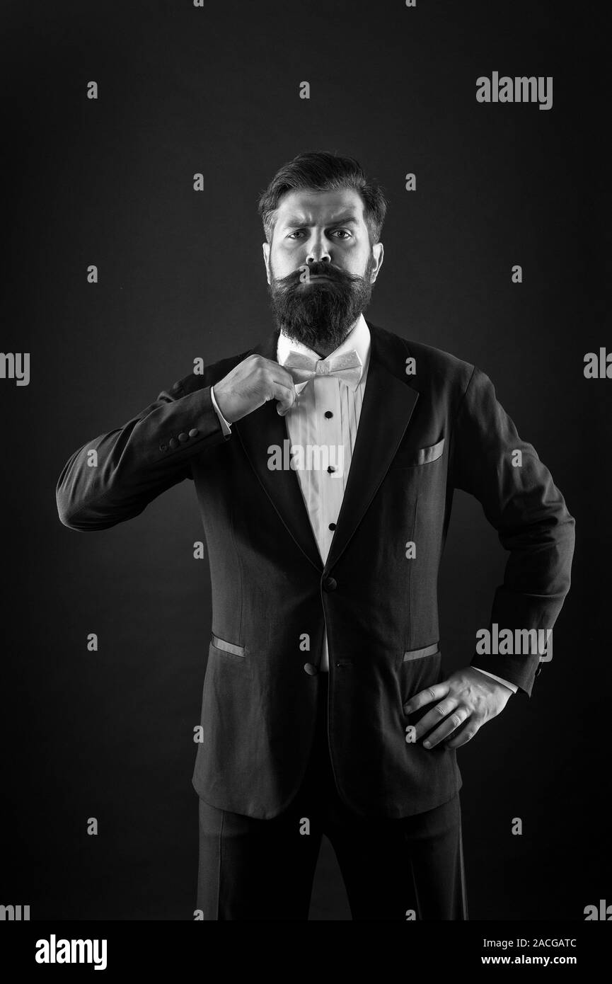 Hipster formal suit tuxedo. Difference between vintage and classic. Official event dress code. Classic style. Menswear classic outfit. Bearded man with bow tie. Well dressed and scrupulously neat. Stock Photo
