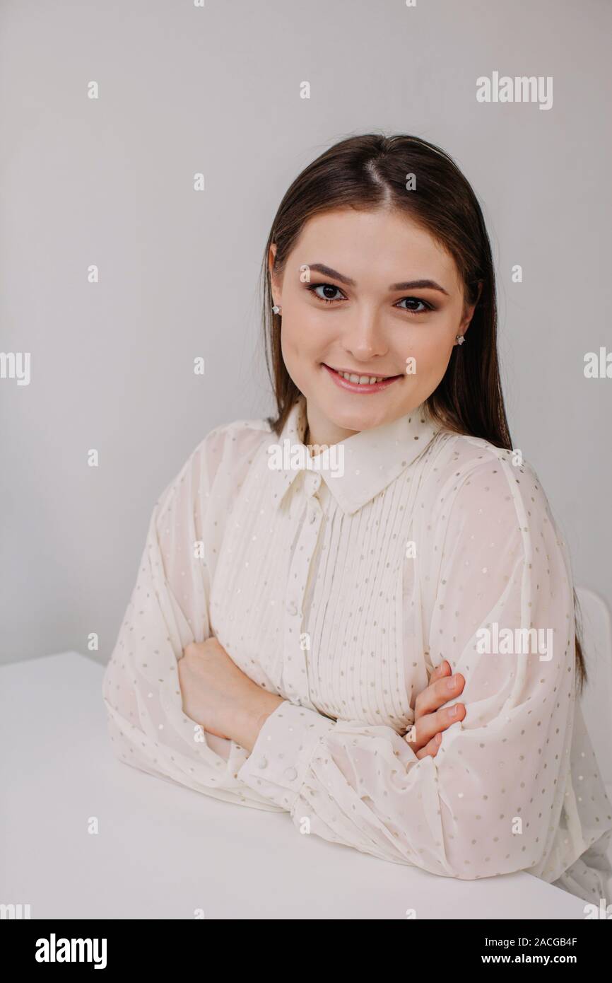 Portrait of a smiling woman with her arms crossed Stock Photo - Alamy