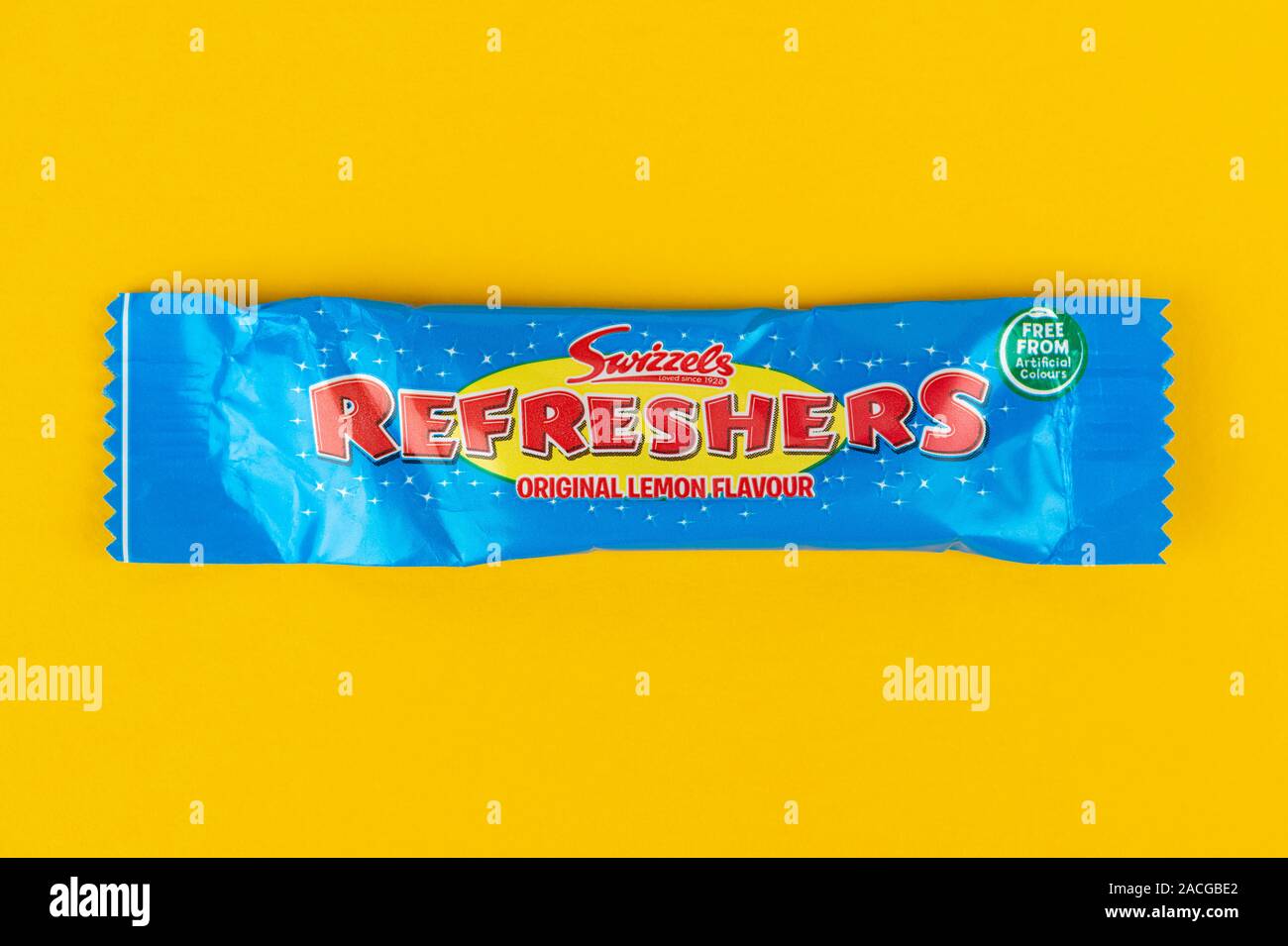 A Swizzels Refreshers bar shot on a yellow background. Stock Photo