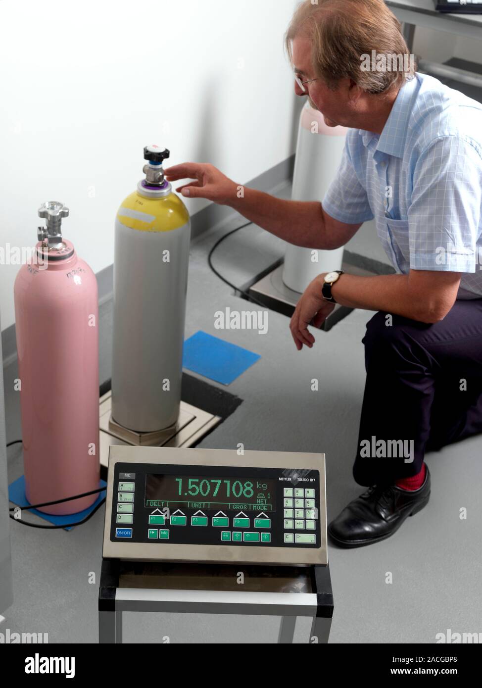 Weighing gas cylinders. Gas cylinder being weighed on scales. The