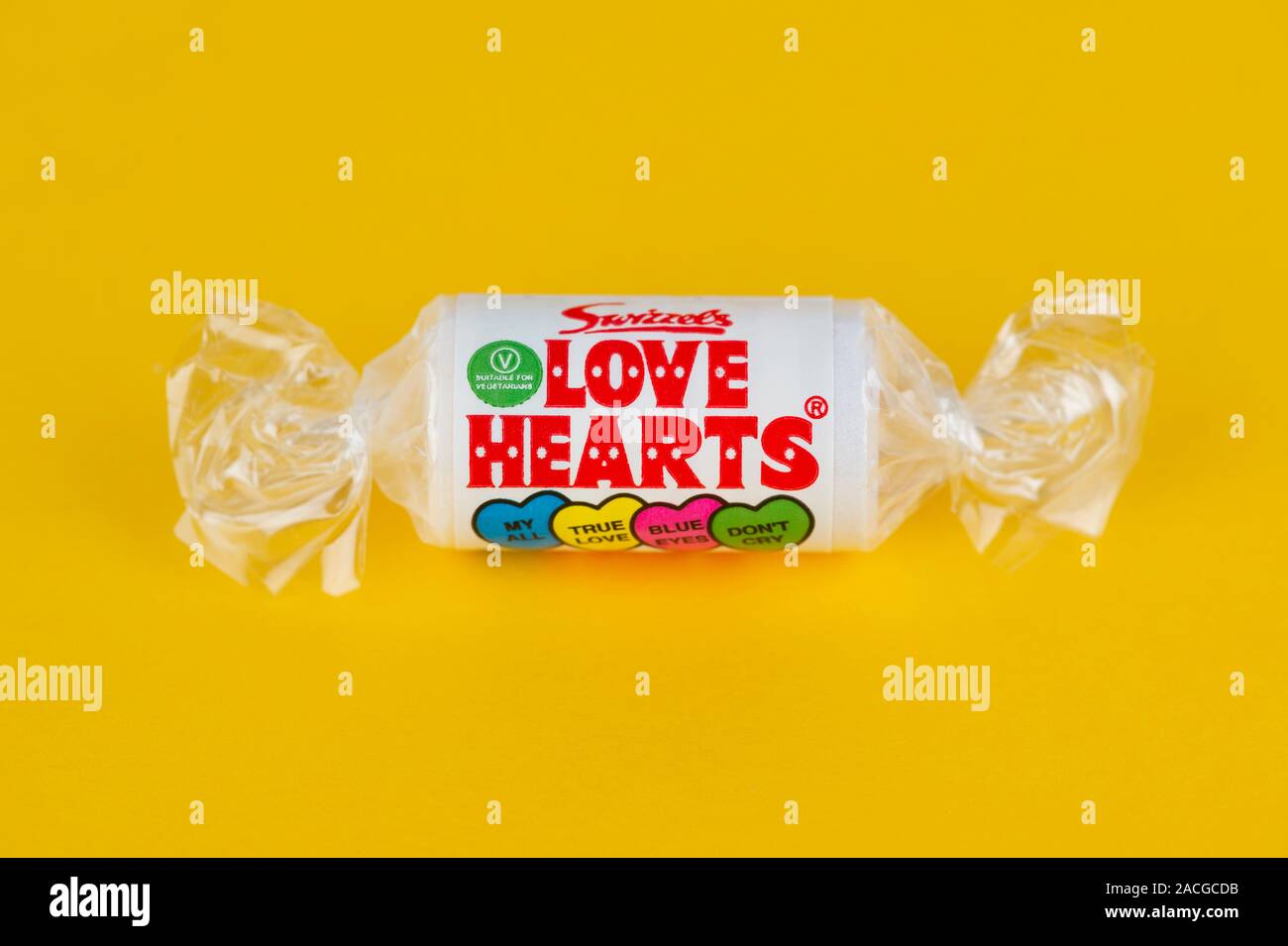 A packet of Swizzels Love Hearts shot on a yellow background. Stock Photo