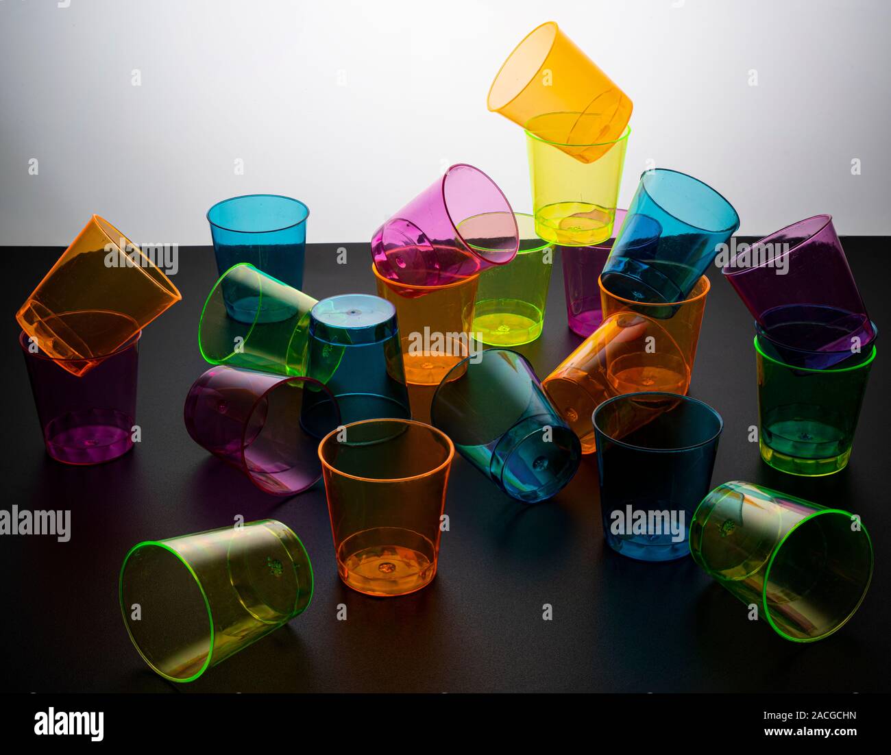 some empty colored glasses scattered on a surface Stock Photo