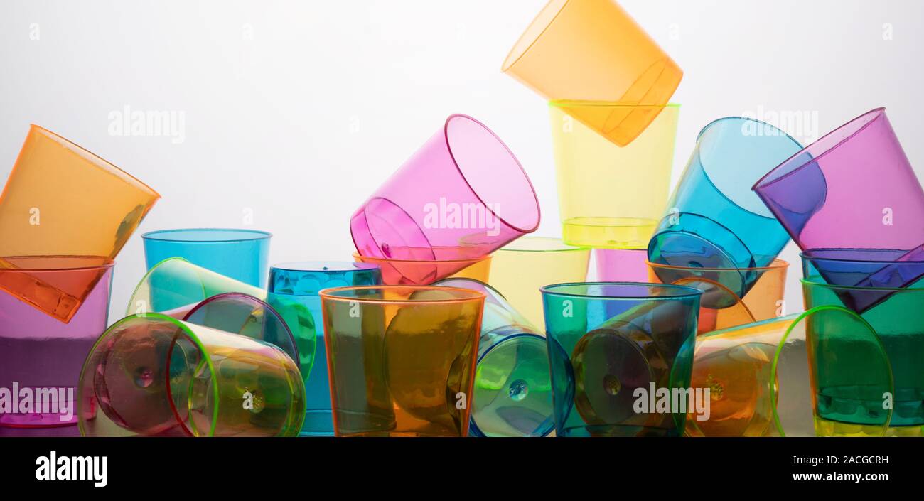 some empty colored glasses scattered on a surface Stock Photo