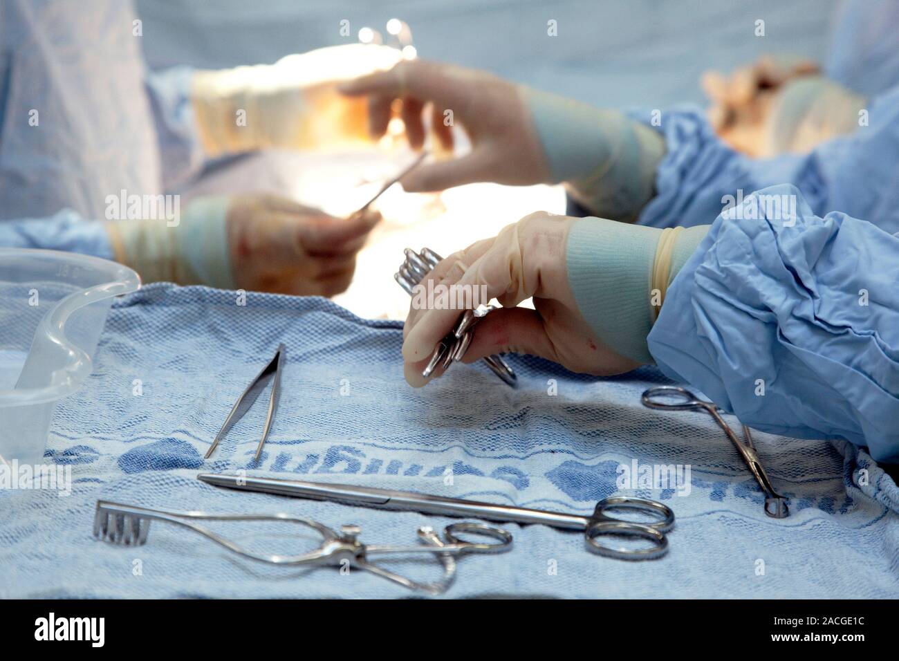 Hernia operation. Surgical assistant keeping track of instruments being