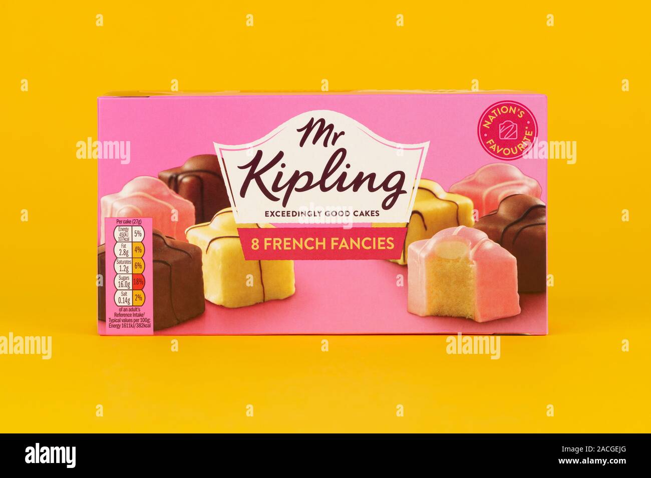 A box of Mr Kipling French Fancies shot on a yellow background. Stock Photo