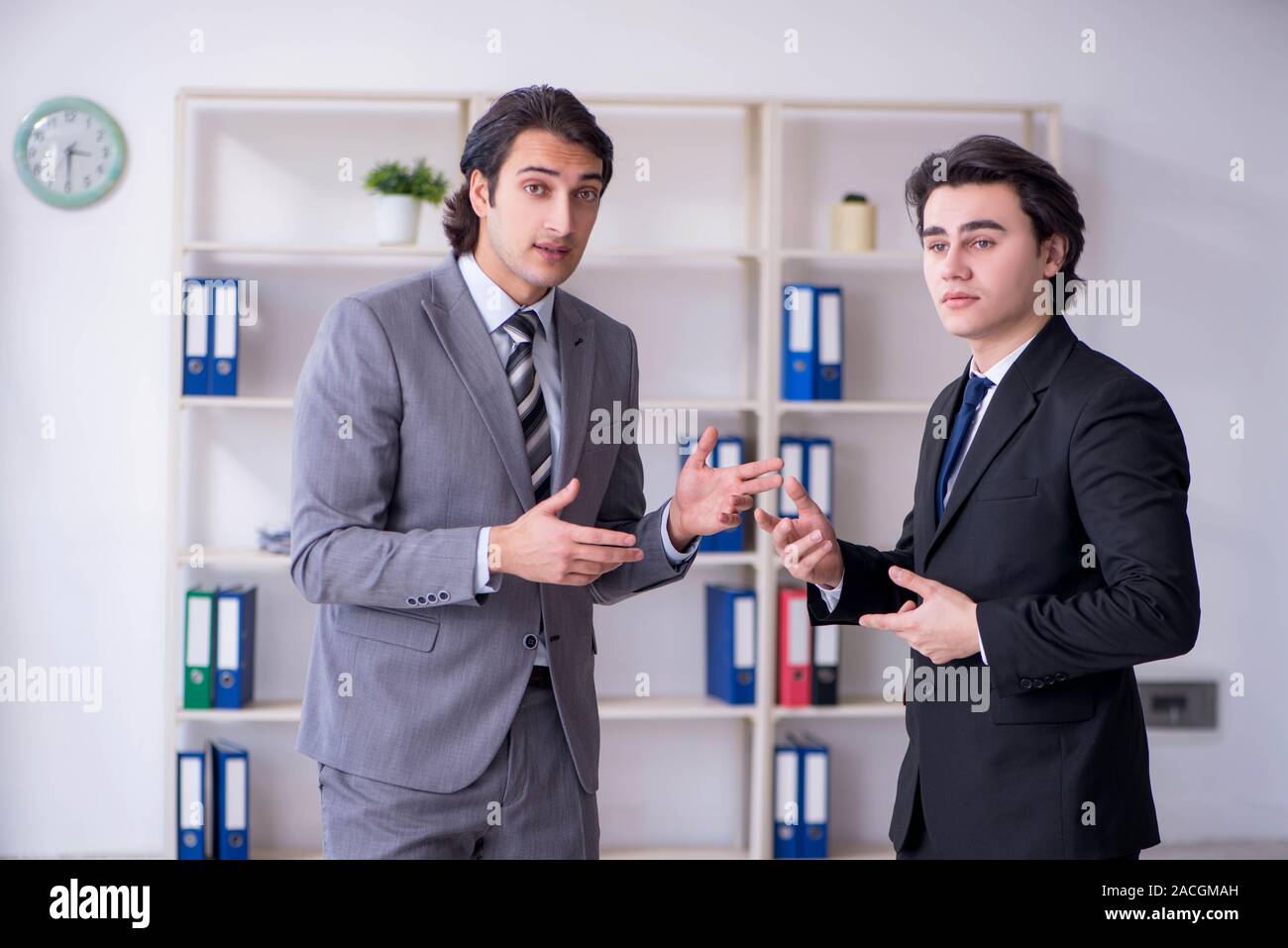 The two young businessmen meeting in the office Stock Photo - Alamy