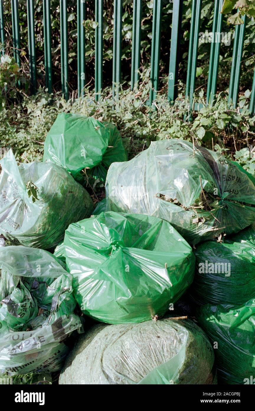Green refuse waiting collection on a street. Photographed in Birmingham